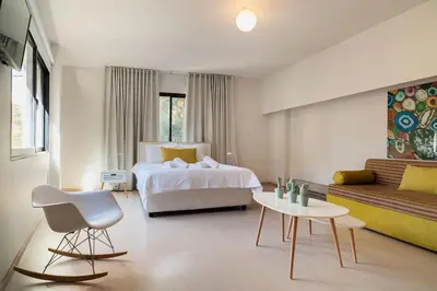 a bedroom with a bed and a couch and a table at Plaka Heart in Athens