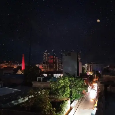 a view of the city at night at Ceramus Apartments Gazi View in Athens