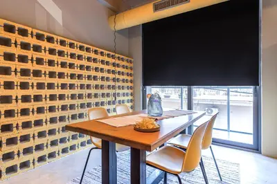 a dining room with a wooden table and chairs at Ceramus Apartments Gazi View in Athens