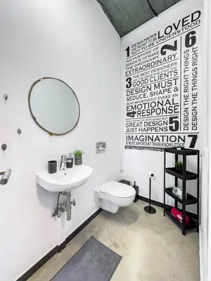 a bathroom with a toilet and a sink and a mirror at Ceramus Apartments Gazi View in Athens