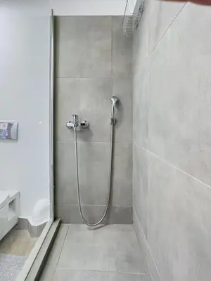 a shower stall in a bathroom with a toilet at Ceramus Apartments Gazi View in Athens