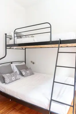 a bedroom with two bunk beds and a ladder at Dioskouros Hostel in Athens