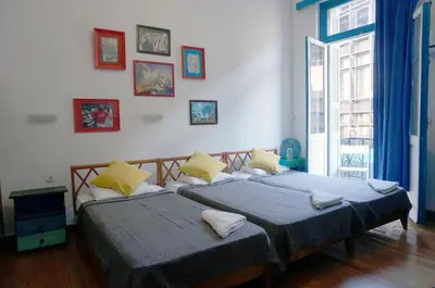 two beds sitting next to each other in a room at Dioskouros Hostel in Athens