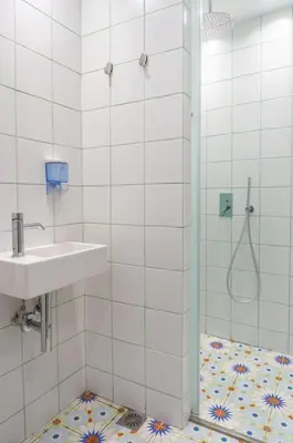 a bathroom with a shower and a sink at Dioskouros Hostel in Athens