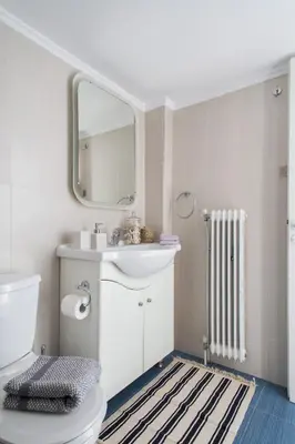a bathroom with a toilet and a sink and a mirror at Stylish Syntagma apartment in Athens