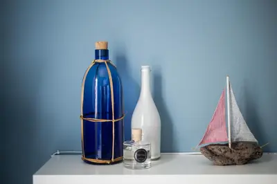 a table with two bottles and a toy boat on it at Stylish Syntagma apartment in Athens