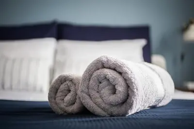 a rolled up towel on top of a bed at Stylish Syntagma apartment in Athens