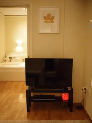 a living room with a flat screen tv on a table at Cosy Flat Posh Quartier Kolonaki in Athens