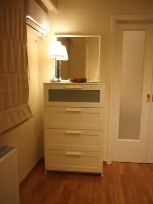 a dresser with a lamp and a mirror in a room at Cosy Flat Posh Quartier Kolonaki in Athens