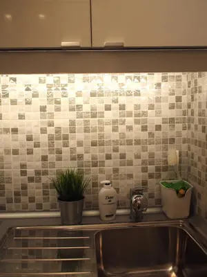 a kitchen with a sink and a tiled wall at Cosy Flat Posh Quartier Kolonaki in Athens