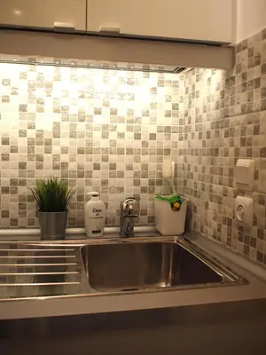 a sink in a kitchen with tiles on the wall at Cosy Flat Posh Quartier Kolonaki in Athens
