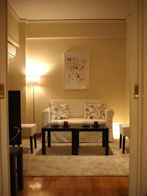 a living room with a couch and a coffee table at Cosy Flat Posh Quartier Kolonaki in Athens