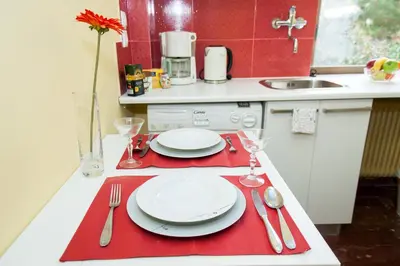 a kitchen with a table with plates and silverware at Stephany Apartment in Athens