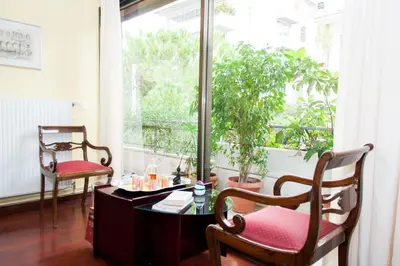 a room with a table and two chairs and a window at Stephany Apartment in Athens