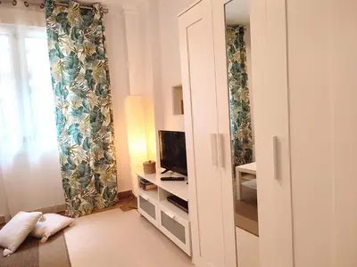 a room with a large cabinet with a tv and a window at Kolonaki Elegant apartment in Athens