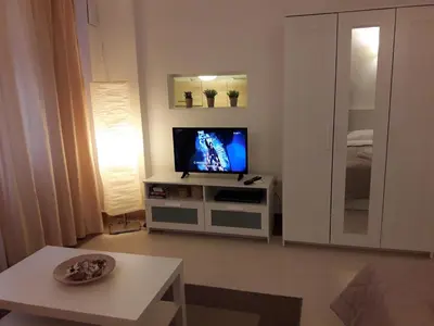 a living room with a flat screen tv on a cabinet at Kolonaki Elegant apartment in Athens
