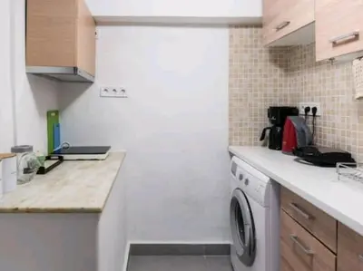 a small kitchen with a washing machine in it at Kolonaki Elegant apartment in Athens