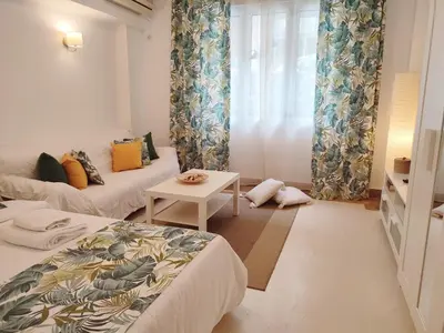 a small room with two beds and a table at Kolonaki Elegant apartment in Athens