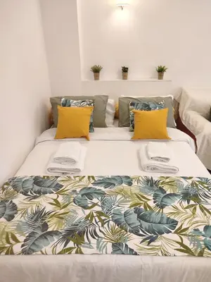 a large bed with a colorful blanket on it at Kolonaki Elegant apartment in Athens