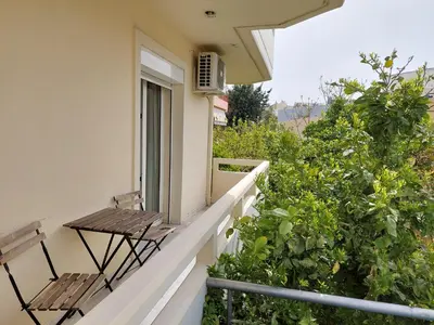 a balcony with two chairs and a table at Krystal Apartment 