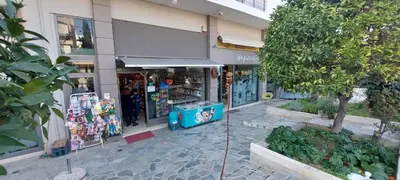 a store front of a building with a tree at Krystal Apartment 