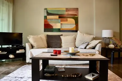 a living room with a couch and a table at Amazing Apartment in Athens