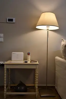 a lamp sitting on a table next to a table with a tableablish at Amazing Apartment in Athens