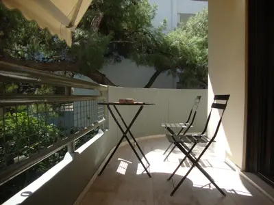 a table and two chairs sitting on a balcony at Amazing Apartment in Athens