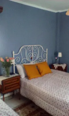 a bedroom with a white bed with yellow pillows at Lepa Kuca in Spáta