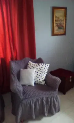 a living room with a chair with pillows on it at Lepa Kuca in Spáta