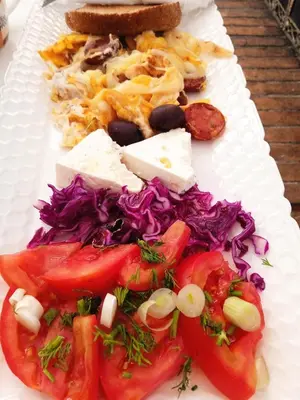 a plate of food with cheese and vegetables on it at Lepa Kuca in Spáta