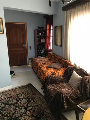 a bedroom with a bed and a couch and a window at Lepa Kuca in Spáta