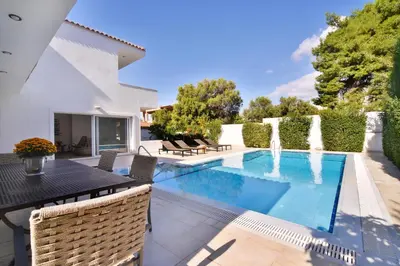 a villa with a swimming pool and a fountain at Villa Noa in Anavissos