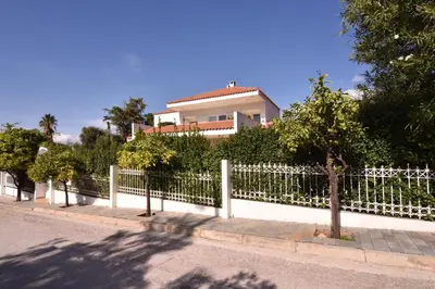 a white fence in front of a house at Villa Noa in Anavissos