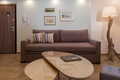 a living room with a couch and a table at Acropolis Quiet Apartment in Athens
