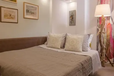 a bedroom with a bed with pillows and a lamp at Acropolis Quiet Apartment in Athens