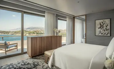 a bedroom with a bed and a large window at Four Seasons Astir Palace Hotel Athens in Athens
