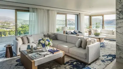 a living room with a couch and a table at Four Seasons Astir Palace Hotel Athens in Athens