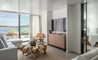 a living room with a view of the water at Four Seasons Astir Palace Hotel Athens in Athens
