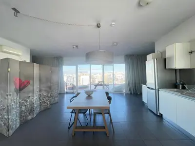 a kitchen with a wooden table in a room at Virgo - Loft with Spectacular View to Acropolis in Athens