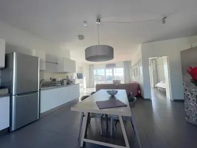 a kitchen with a table and a refrigerator at Virgo - Loft with Spectacular View to Acropolis in Athens