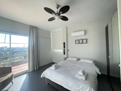 a bedroom with a bed and a ceiling fan at Virgo - Loft with Spectacular View to Acropolis in Athens
