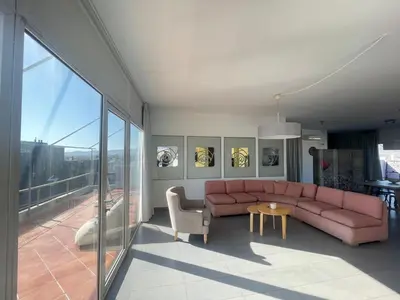 a living room with a pink couch and a table at Virgo - Loft with Spectacular View to Acropolis in Athens