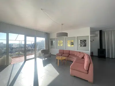 a living room with a pink couch and a table at Virgo - Loft with Spectacular View to Acropolis in Athens