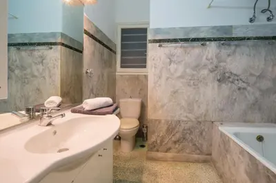 a bathroom with a sink and a toilet and a tub at Capricorn - Luxurious apartment in Kolonaki in Athens