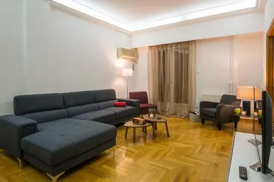 a living room with a couch and a table at Capricorn - Luxurious apartment in Kolonaki in Athens