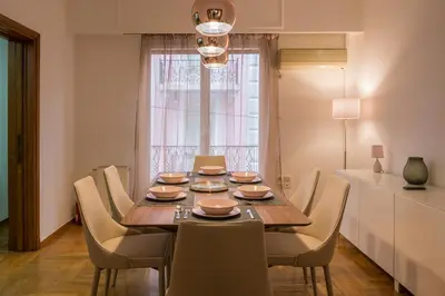 a dining room with a wooden table and chairs at Capricorn - Luxurious apartment in Kolonaki in Athens