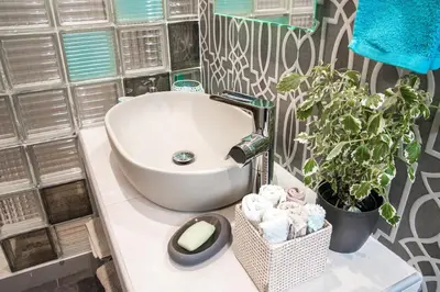a bathroom with a white sink and a plant at Super Loft With Acropolis View in Athens
