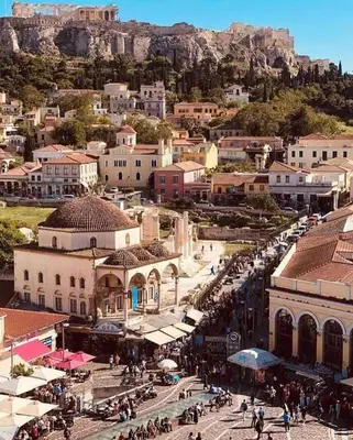 a crowd of people walking around a city witharios at Super Loft With Acropolis View in Athens