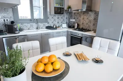 a kitchen with a table with a bowl of oranges on it at Super Loft With Acropolis View in Athens